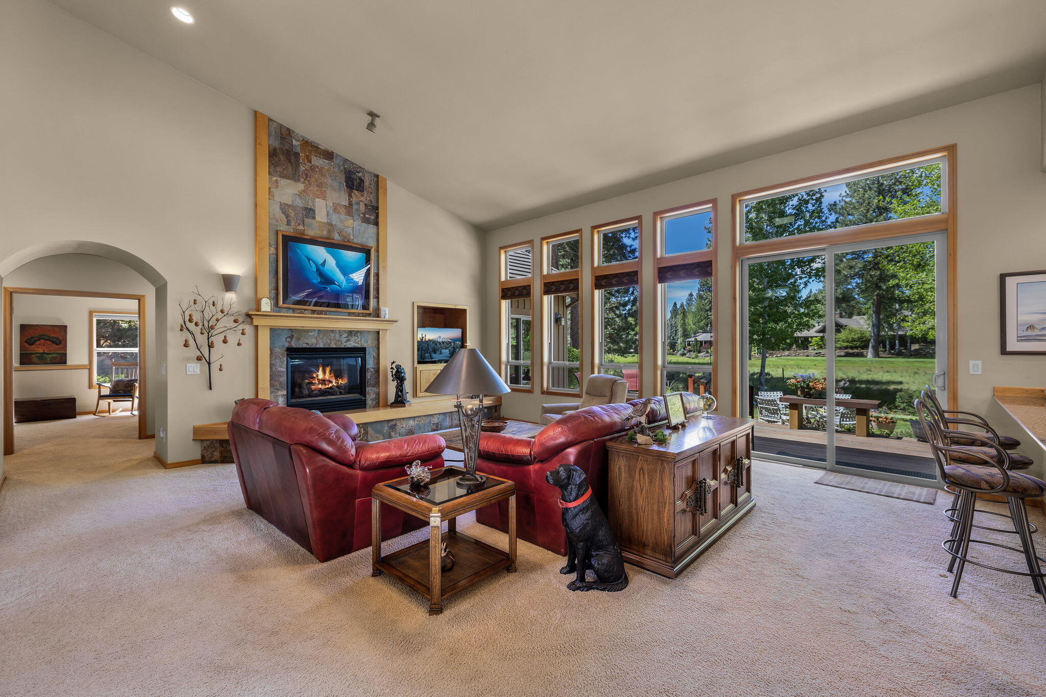 19574 Green Lakes Loop Bend, OR 97702 - Photo 5 of 41 The spacious great room features high ceilings, expansive windows, and a comfortable connection to the private fairway setting beyond.