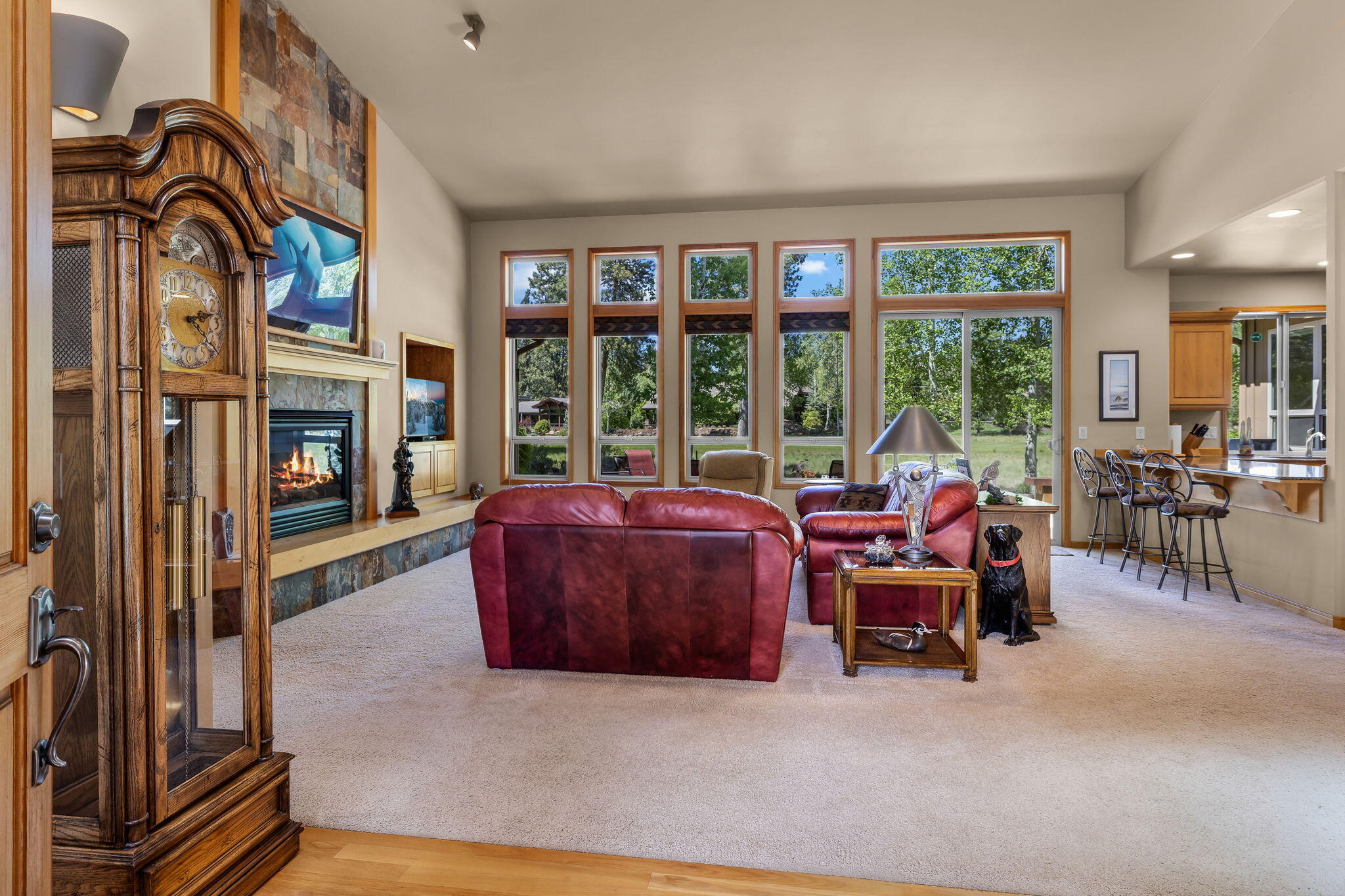 19574 Green Lakes Loop Bend, OR 97702 - Photo 8 of 41 Large windows and sliding doors fill the great room with natural light while framing views toward the patio, lawn, and 17th fairway.