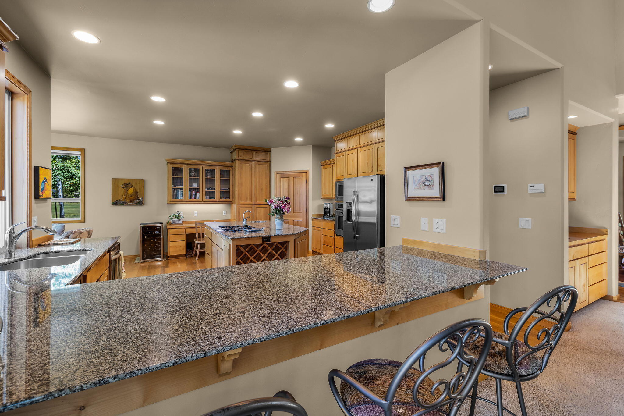 19574 Green Lakes Loop Bend, OR 97702 - Photo 9 of 41 A spacious breakfast bar and open connection to the kitchen create an easy gathering spot for everyday living and casual entertaining.