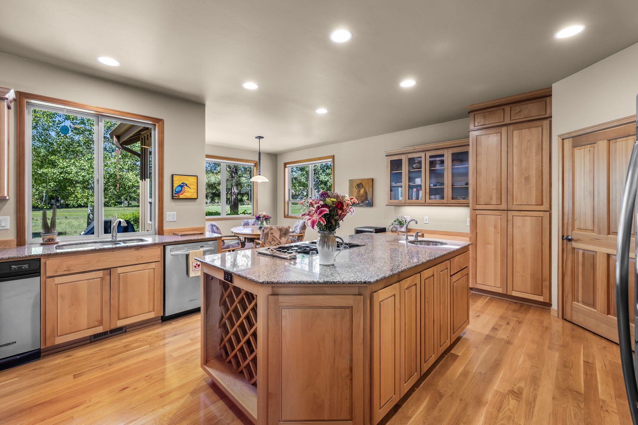 19574 Green Lakes Loop Bend, OR 97702 - Photo 10 of 41 The well-maintained kitchen features abundant cabinetry, a large center island, hardwood flooring, and views to the surrounding landscape.