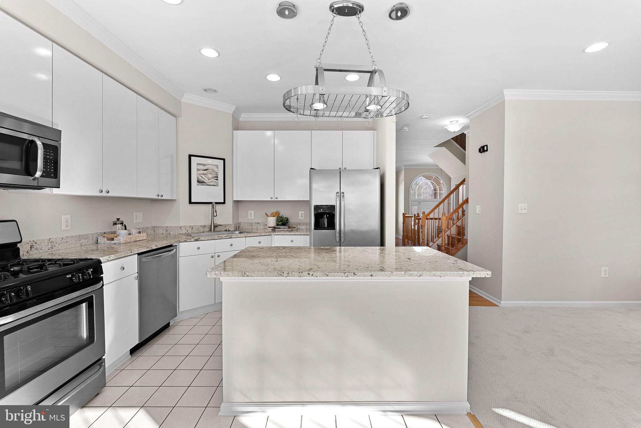 1733 Stuart Pointe Lane Herndon, VA 20194 - Photo 15 of 49 a kitchen with stainless steel appliances granite countertop a sink a stove a refrigerator and cabinets