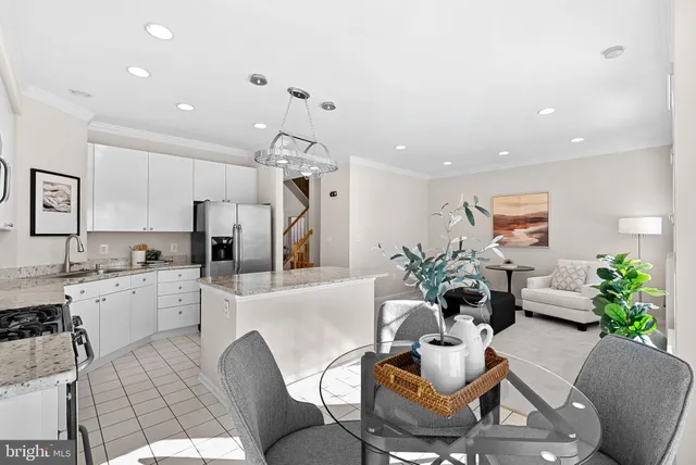 a living room with furniture kitchen and a chandelier