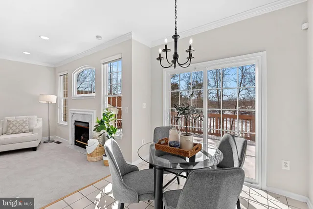 a living room with furniture a fireplace and a chandelier