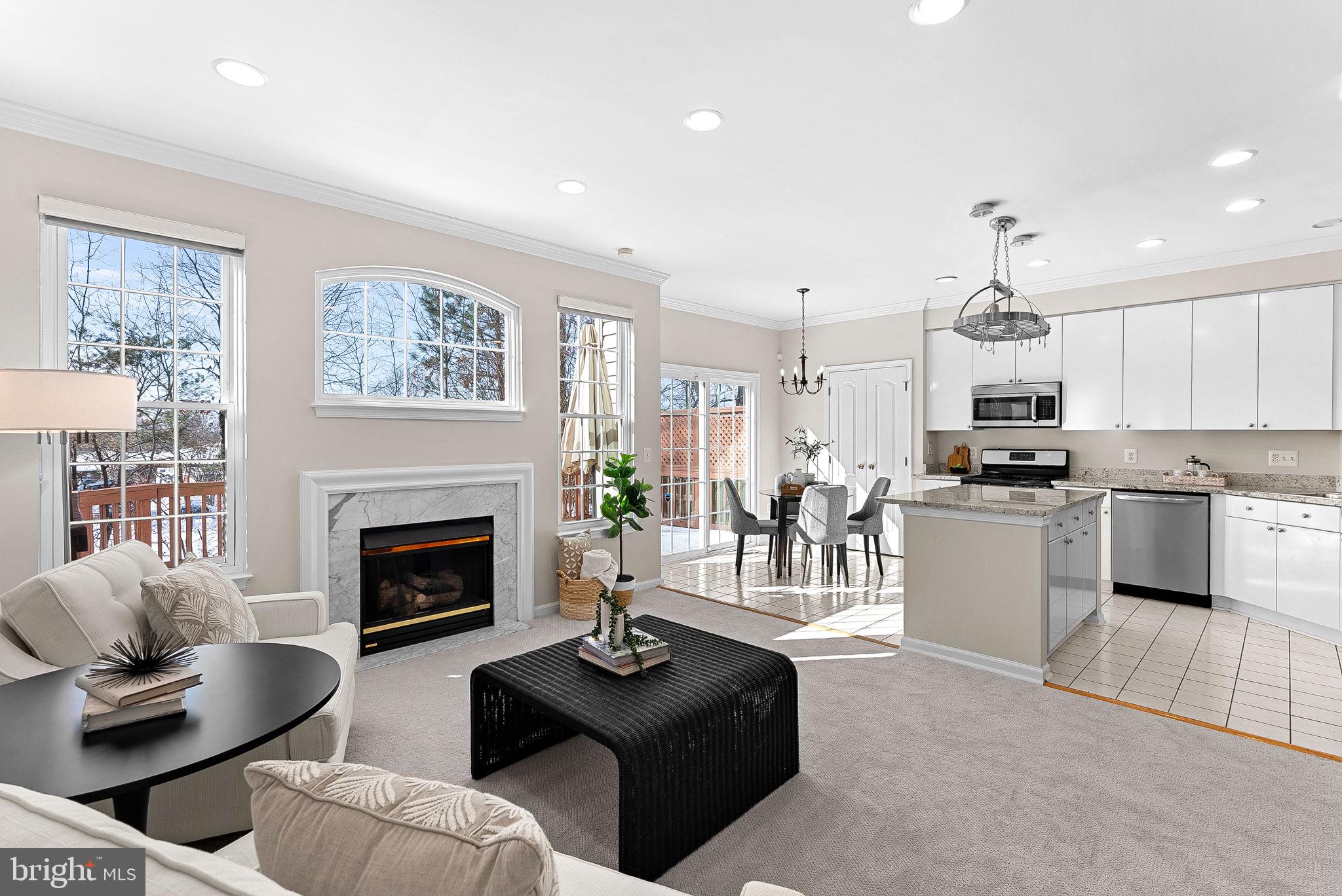 1733 Stuart Pointe Lane Herndon, VA 20194 - Photo 18 of 49 a living room with furniture fireplace and kitchen view