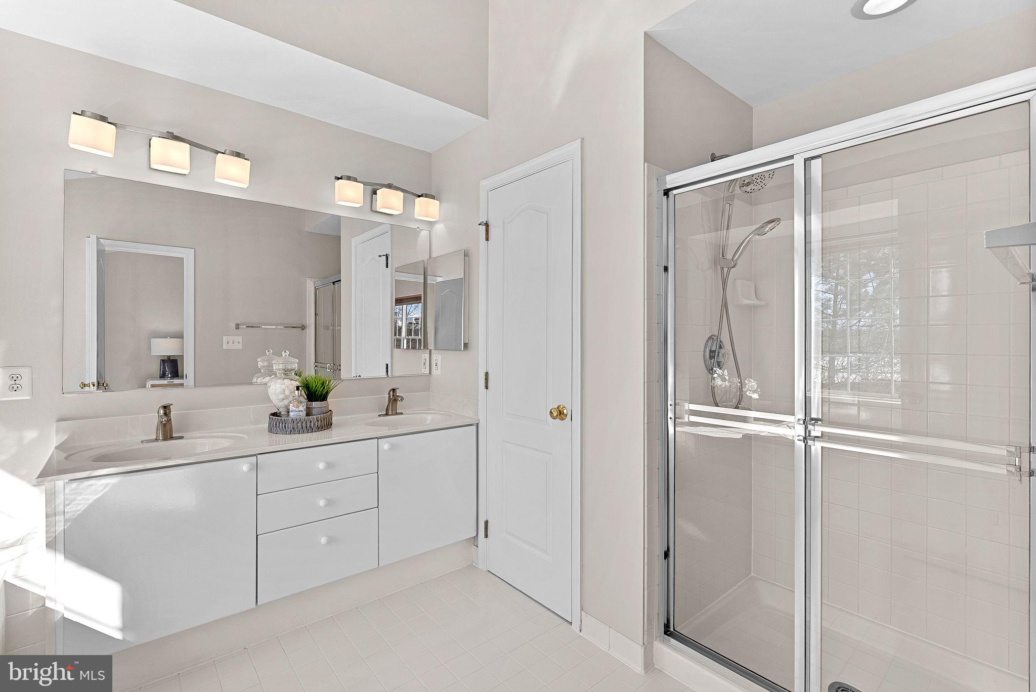 1733 Stuart Pointe Lane Herndon, VA 20194 - Photo 28 of 49 a bathroom with a double vanity sink mirror and shower