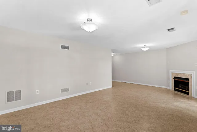 an empty room with fireplace