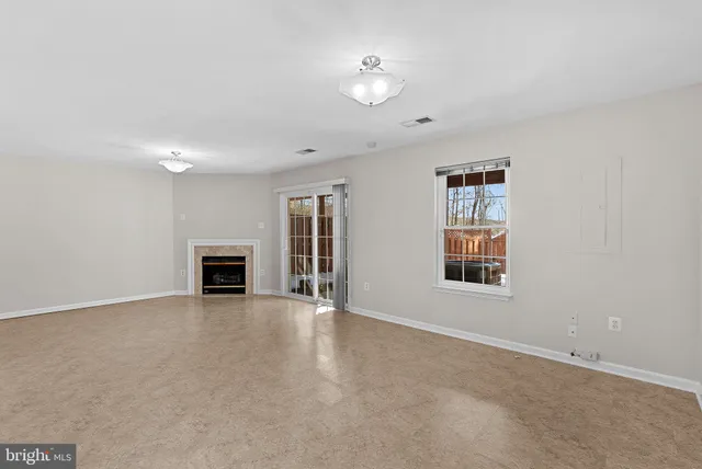 a view of empty room with a fireplace
