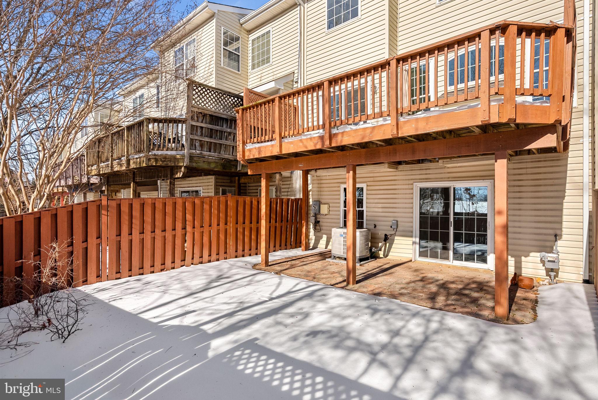 1733 Stuart Pointe Lane Herndon, VA 20194 - Photo 48 of 49 a view of a building with a bench in patio