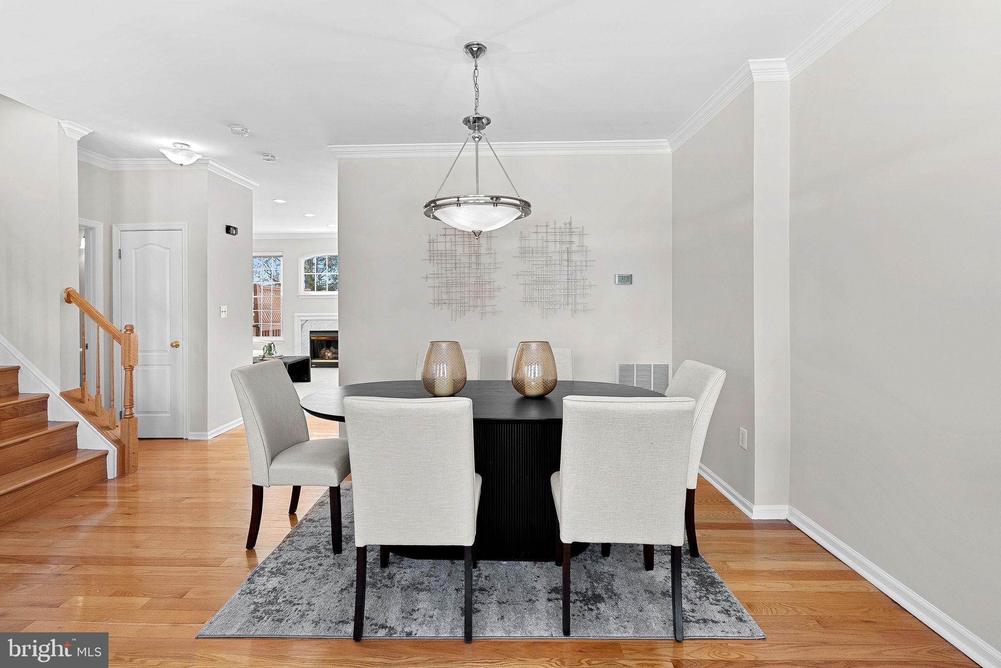 1733 Stuart Pointe Lane Herndon, VA 20194 - Photo 9 of 49 a view of a dining room with furniture and wooden floor
