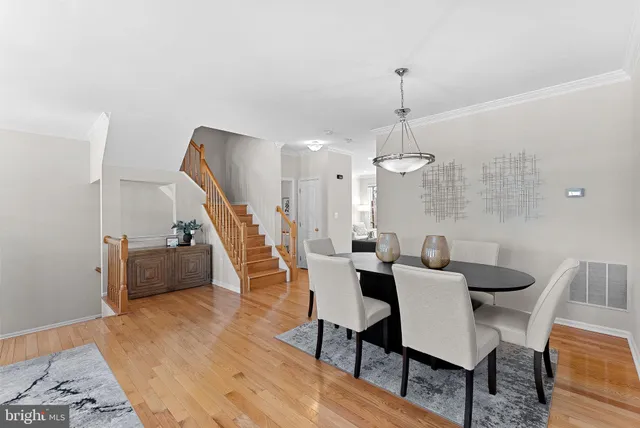 a dining room with furniture and wooden floor