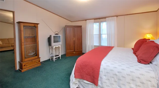 a bed room with a bed and a chair