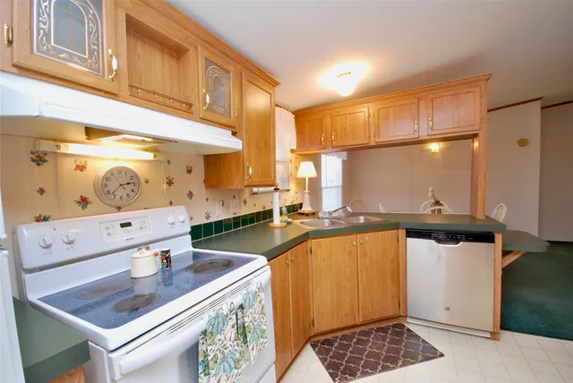 a bathroom with a granite countertop sink a mirror a bathtub and shower