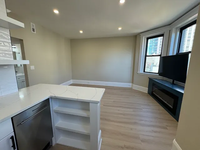a view of room with window and wooden floor