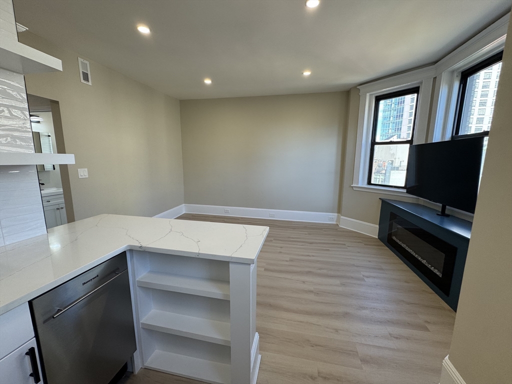 41 Edgerly Road, Unit 32 Boston, MA 02115 - Photo 3 of 13 a view of room with window and wooden floor