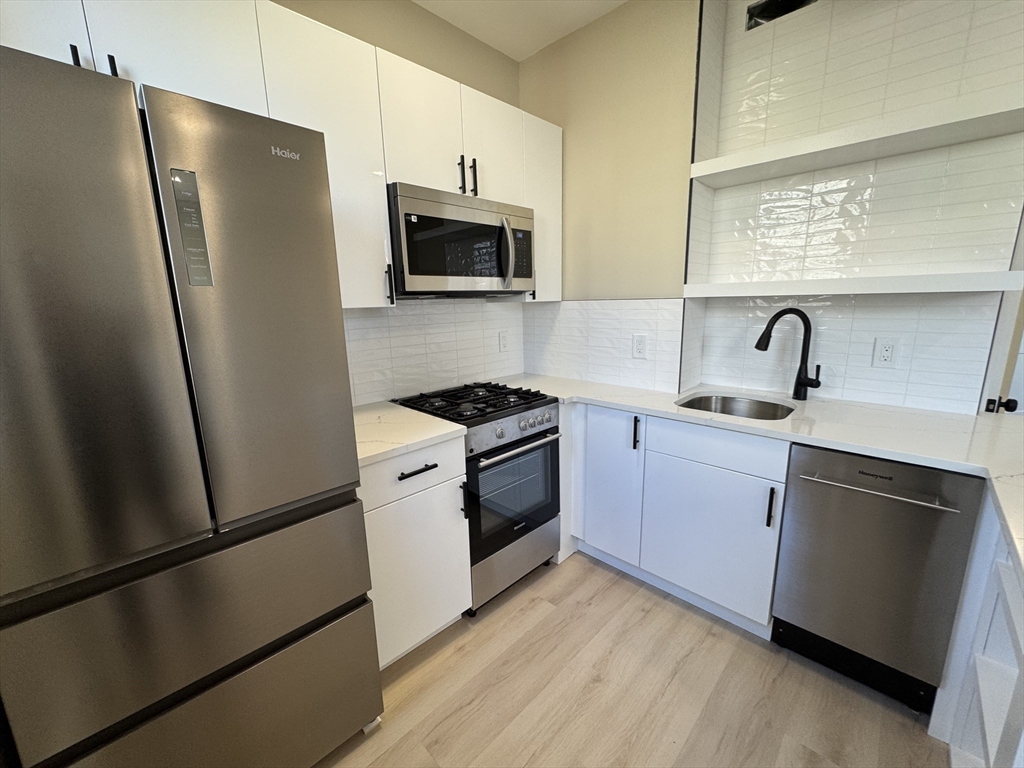 41 Edgerly Road, Unit 32 Boston, MA 02115 - Photo 5 of 13 a kitchen with a refrigerator stove and sink