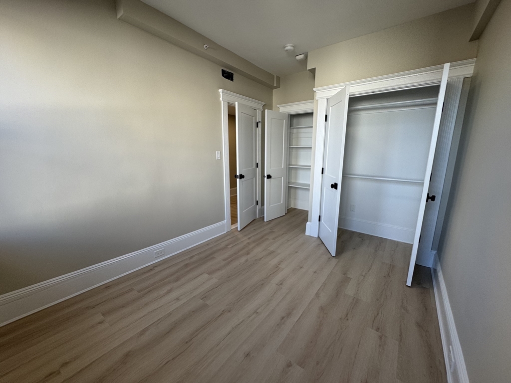 41 Edgerly Road, Unit 32 Boston, MA 02115 - Photo 8 of 13 a view of wooden floor in an empty room