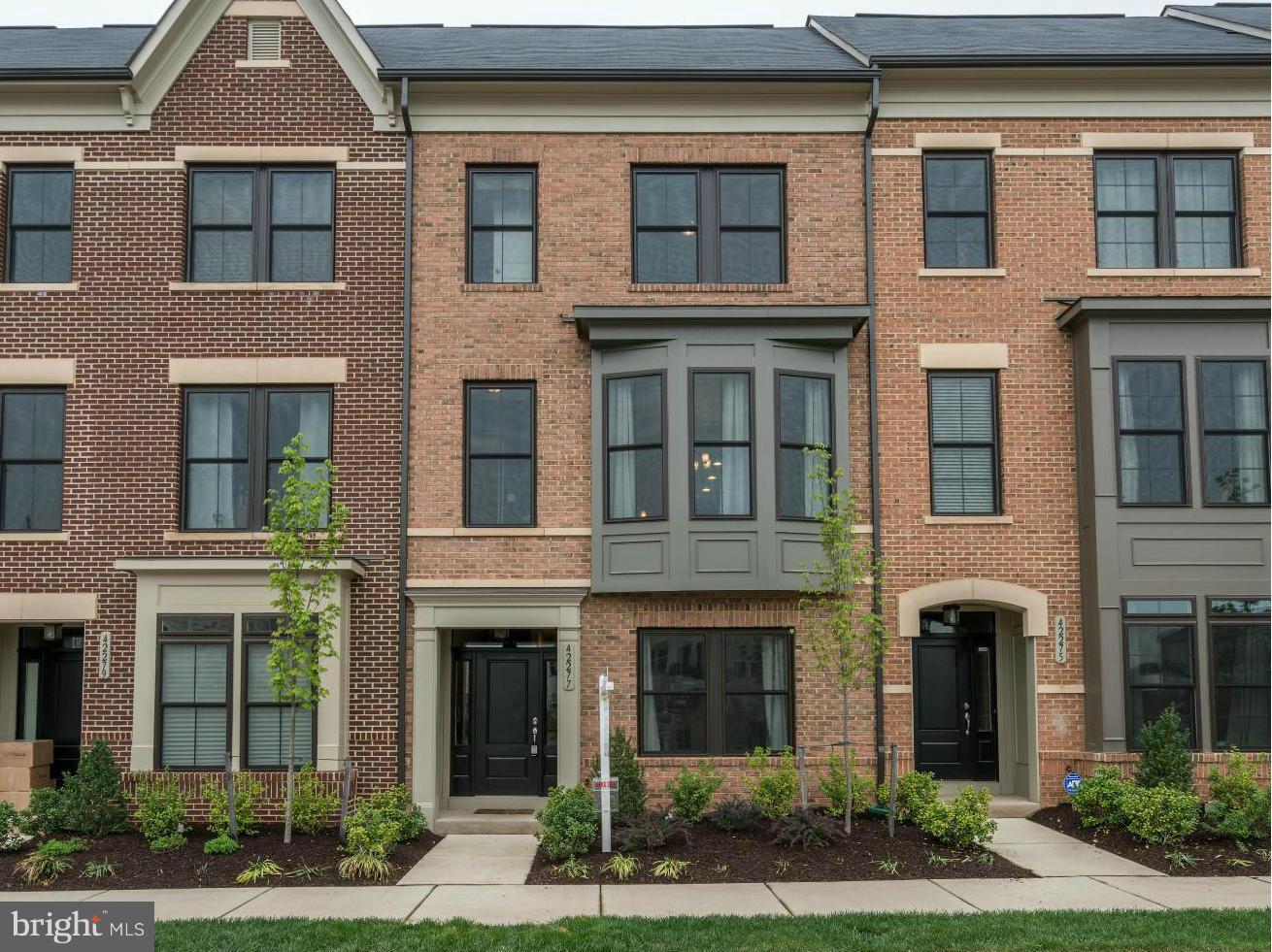 42277 Riggins Ridge Terrace Ashburn, VA 20148 - Photo 1 of 30 a front view of a brick house many windows and large windows