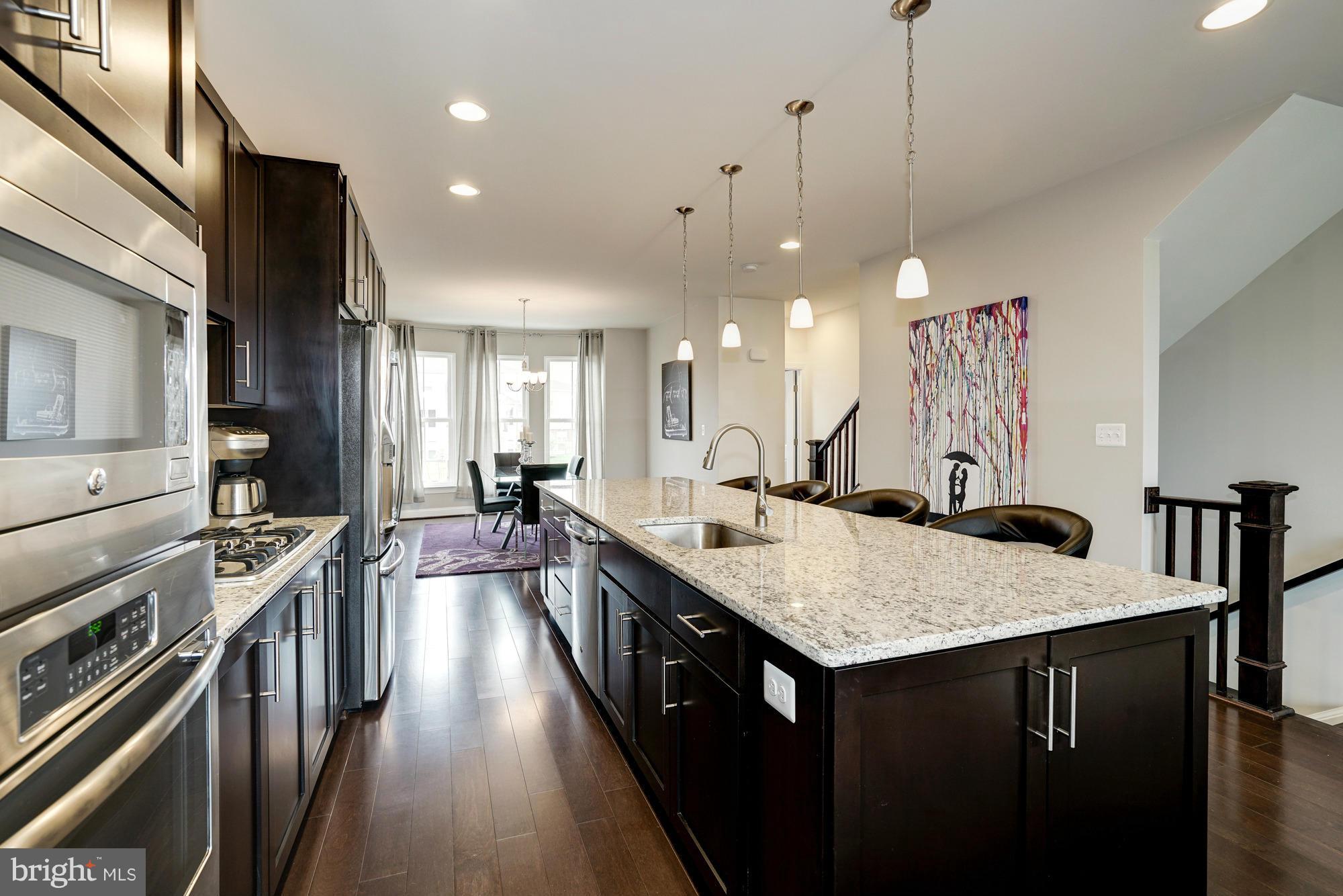 42277 Riggins Ridge Terrace Ashburn, VA 20148 - Photo 11 of 30 a kitchen with counter top space a sink appliances and cabinets