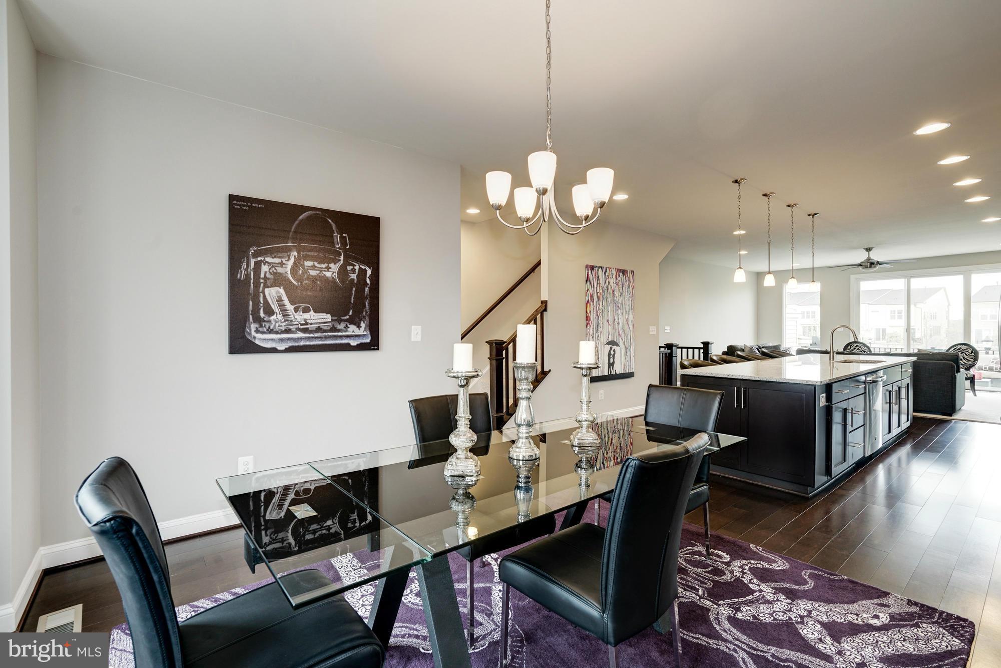 42277 Riggins Ridge Terrace Ashburn, VA 20148 - Photo 14 of 30 a view of a dining room with furniture a rug and wooden floor