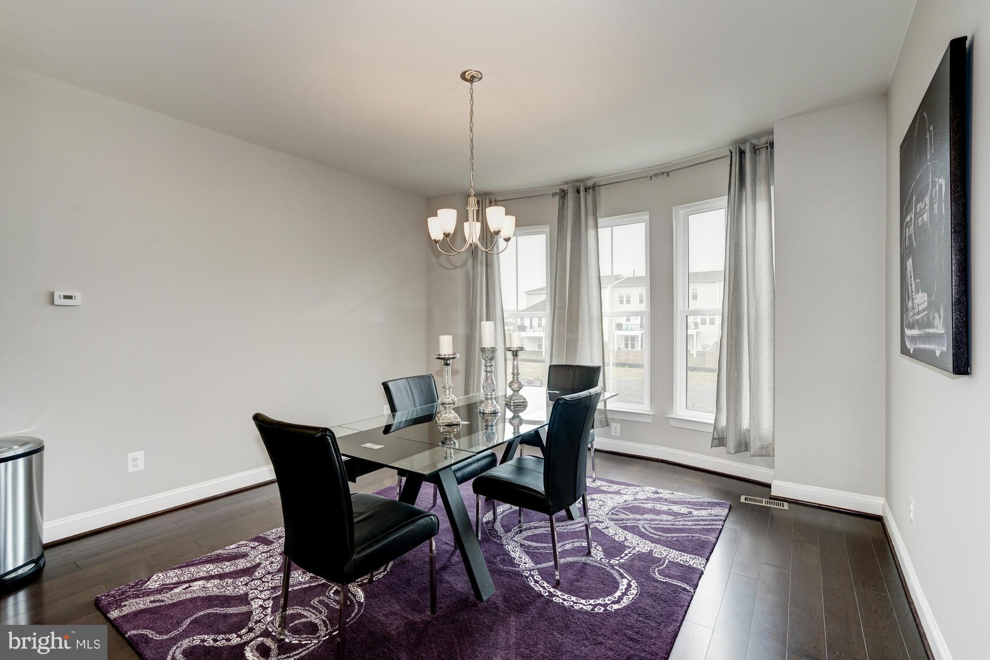 42277 Riggins Ridge Terrace Ashburn, VA 20148 - Photo 15 of 30 a view of a dining room with furniture and wooden floor