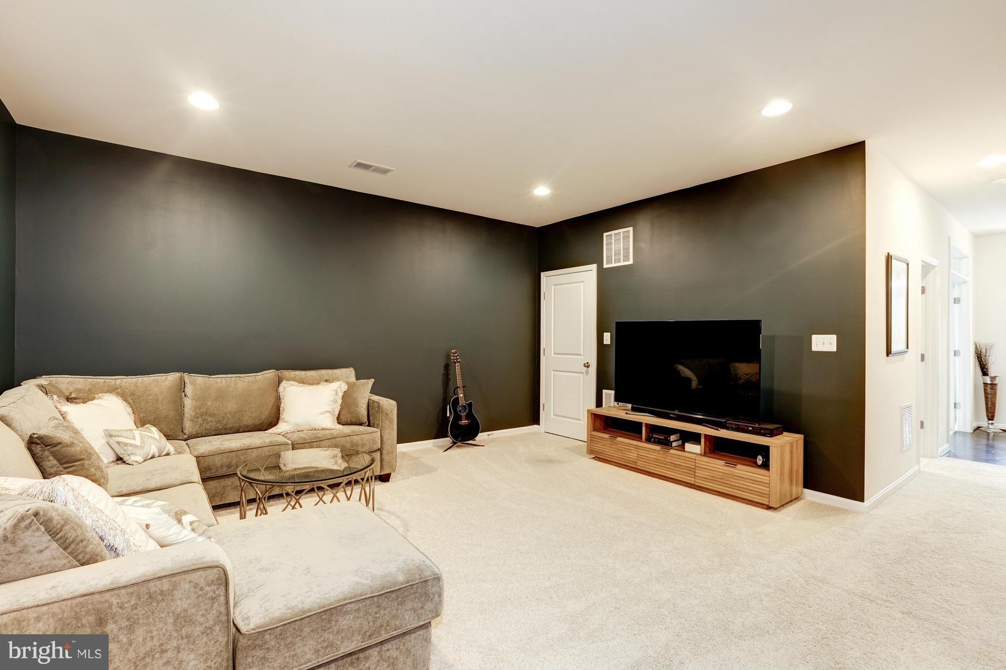 42277 Riggins Ridge Terrace Ashburn, VA 20148 - Photo 25 of 30 a living room with furniture and a flat screen tv