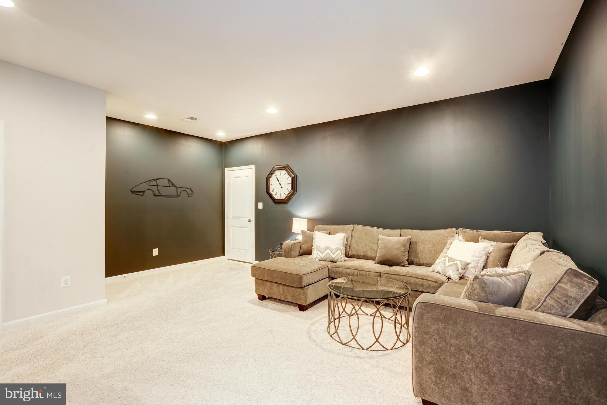 42277 Riggins Ridge Terrace Ashburn, VA 20148 - Photo 26 of 30 a living room with furniture and a ceiling fan