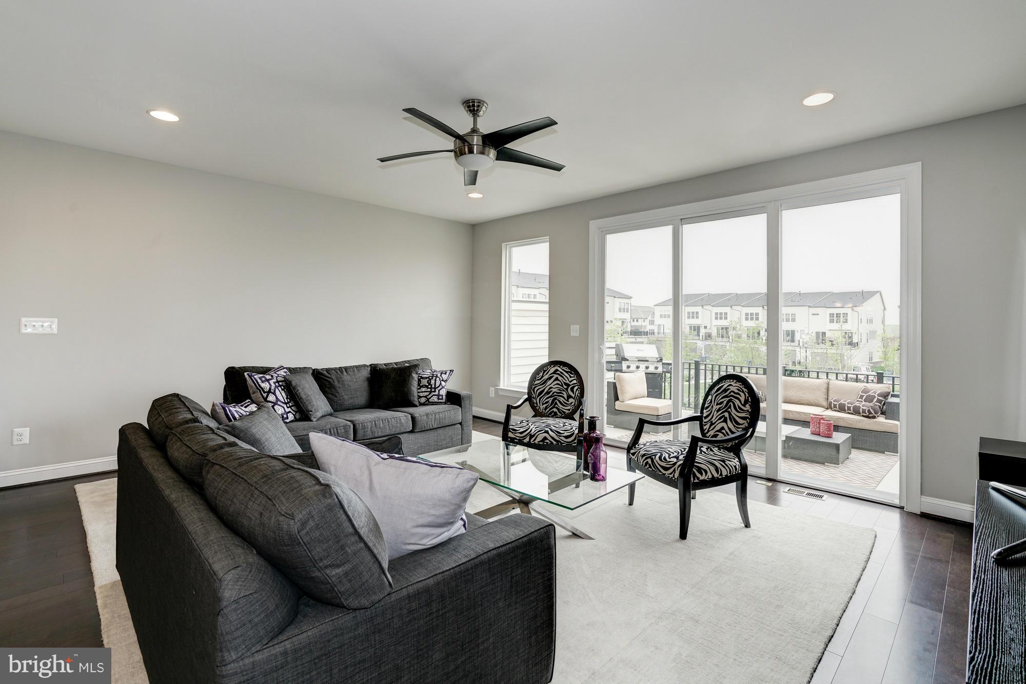 42277 Riggins Ridge Terrace Ashburn, VA 20148 - Photo 7 of 30 a living room with couches and a large window with outer view