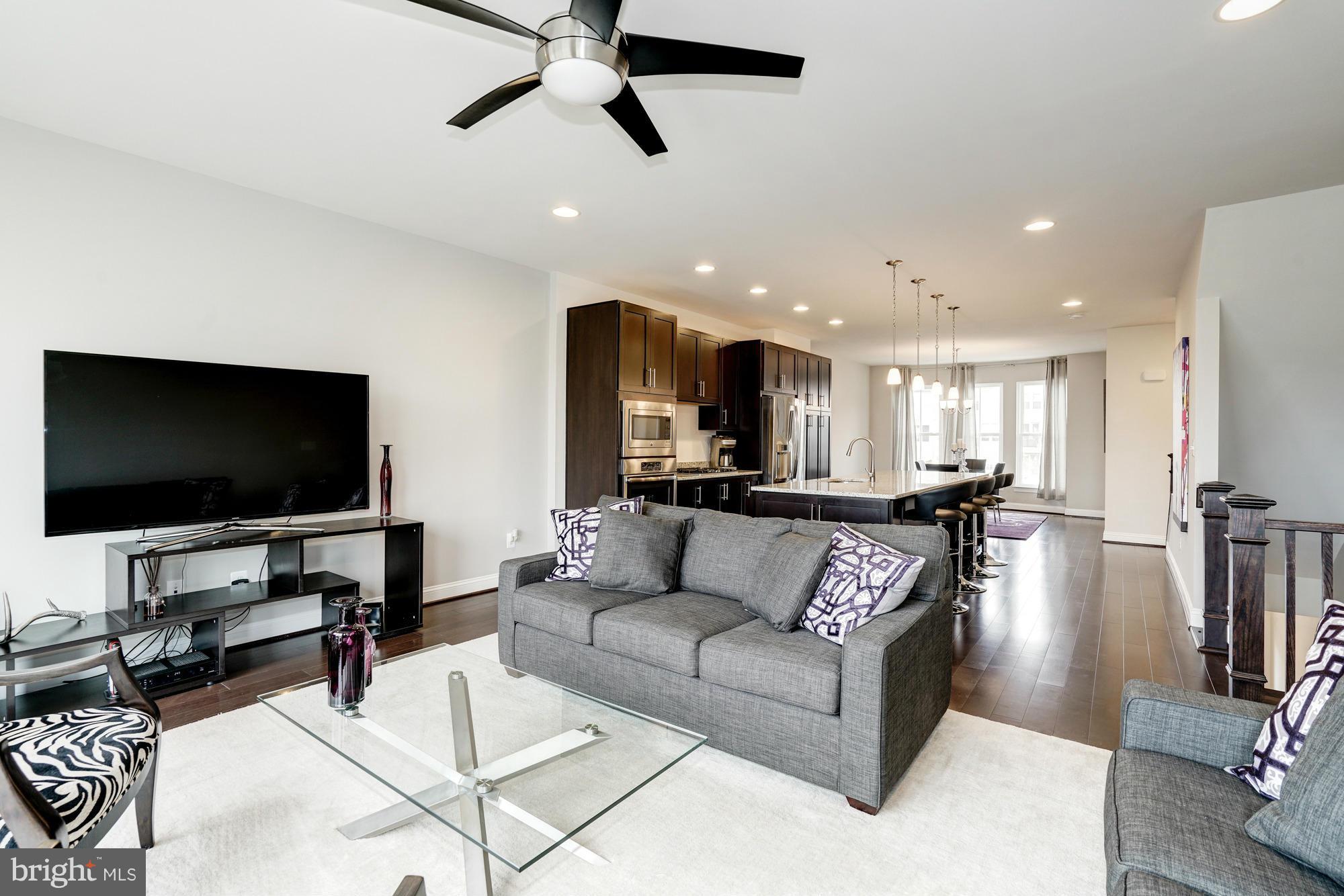 42277 Riggins Ridge Terrace Ashburn, VA 20148 - Photo 9 of 30 a living room with furniture and a flat screen tv