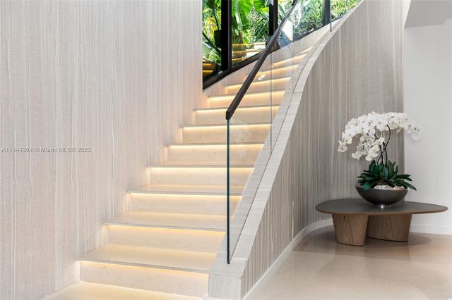 a kitchen with stainless steel appliances kitchen island granite countertop a table and chairs in it