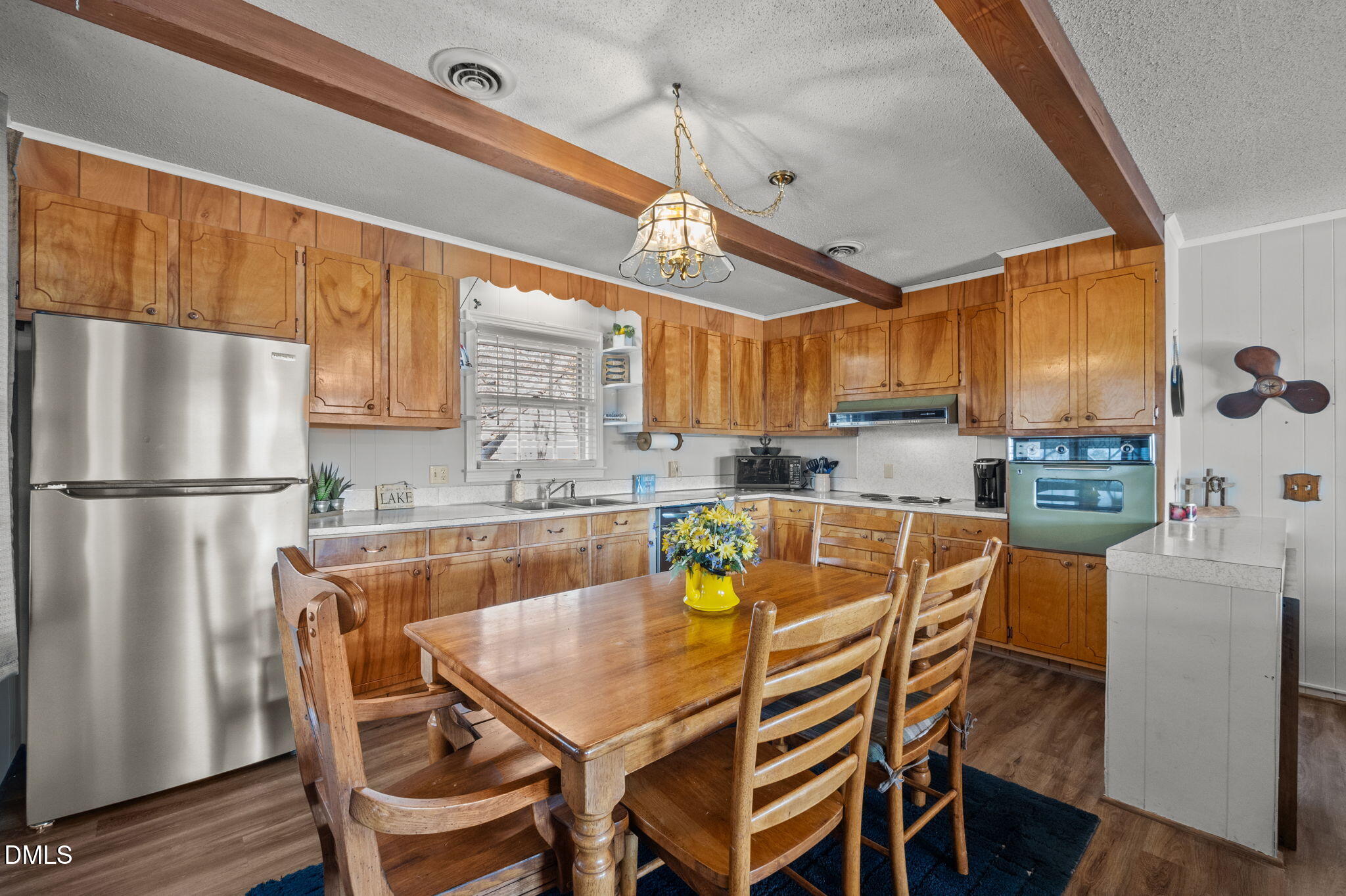 154 Spinnaker Lane Semora, NC 27343 - Photo 19 of 61 a kitchen with stainless steel appliances granite countertop a dining table chairs refrigerator and sink