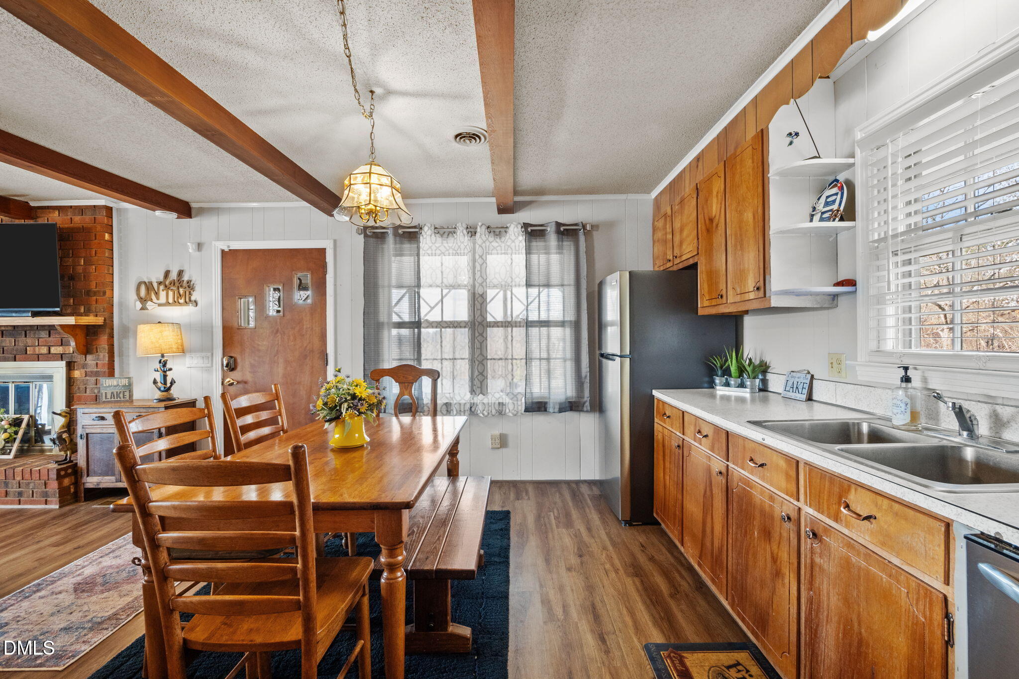 154 Spinnaker Lane Semora, NC 27343 - Photo 20 of 61 a kitchen with a table chairs sink and cabinets