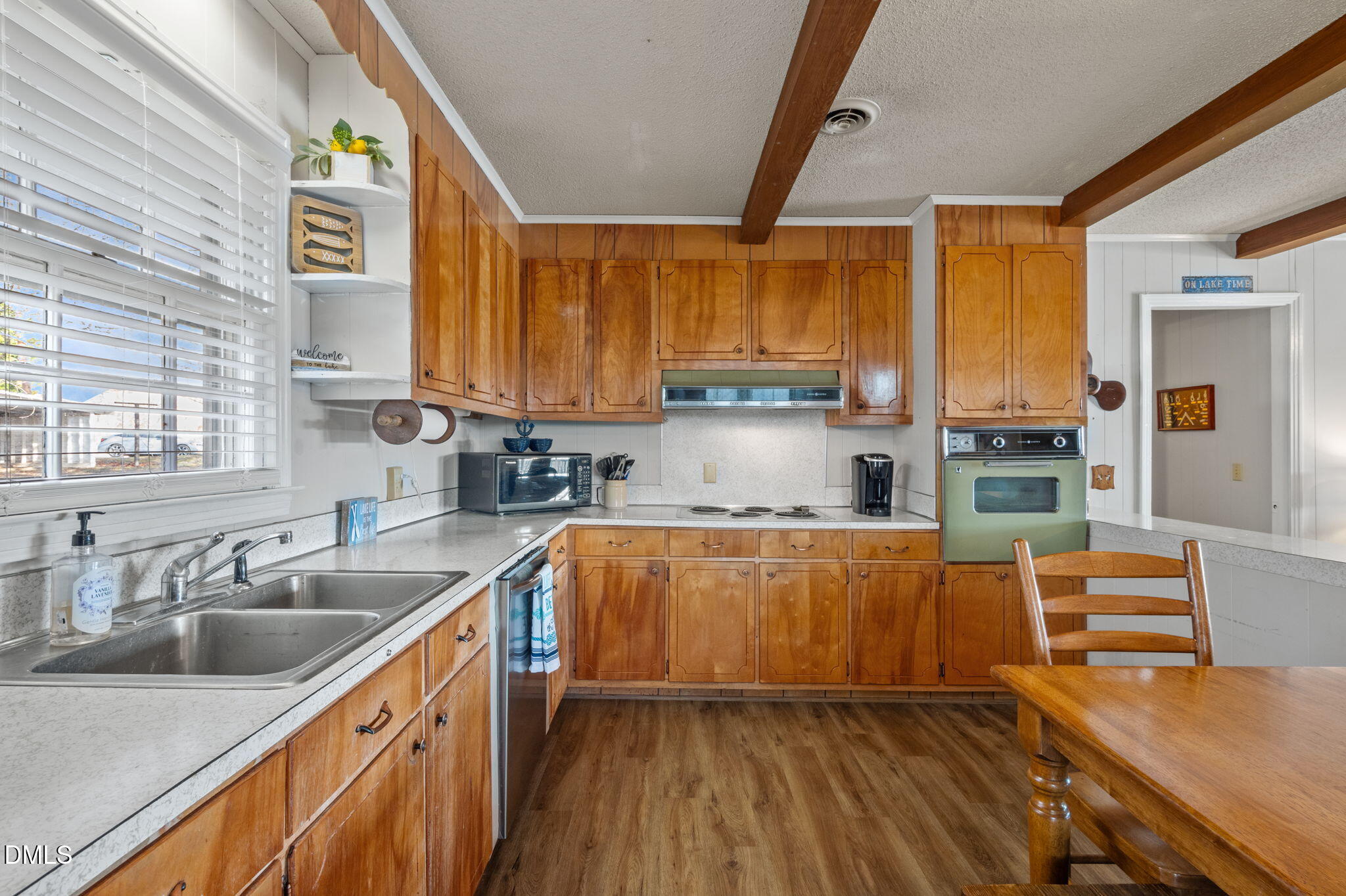 154 Spinnaker Lane Semora, NC 27343 - Photo 21 of 61 a kitchen with stainless steel appliances a sink a stove and a wooden floors
