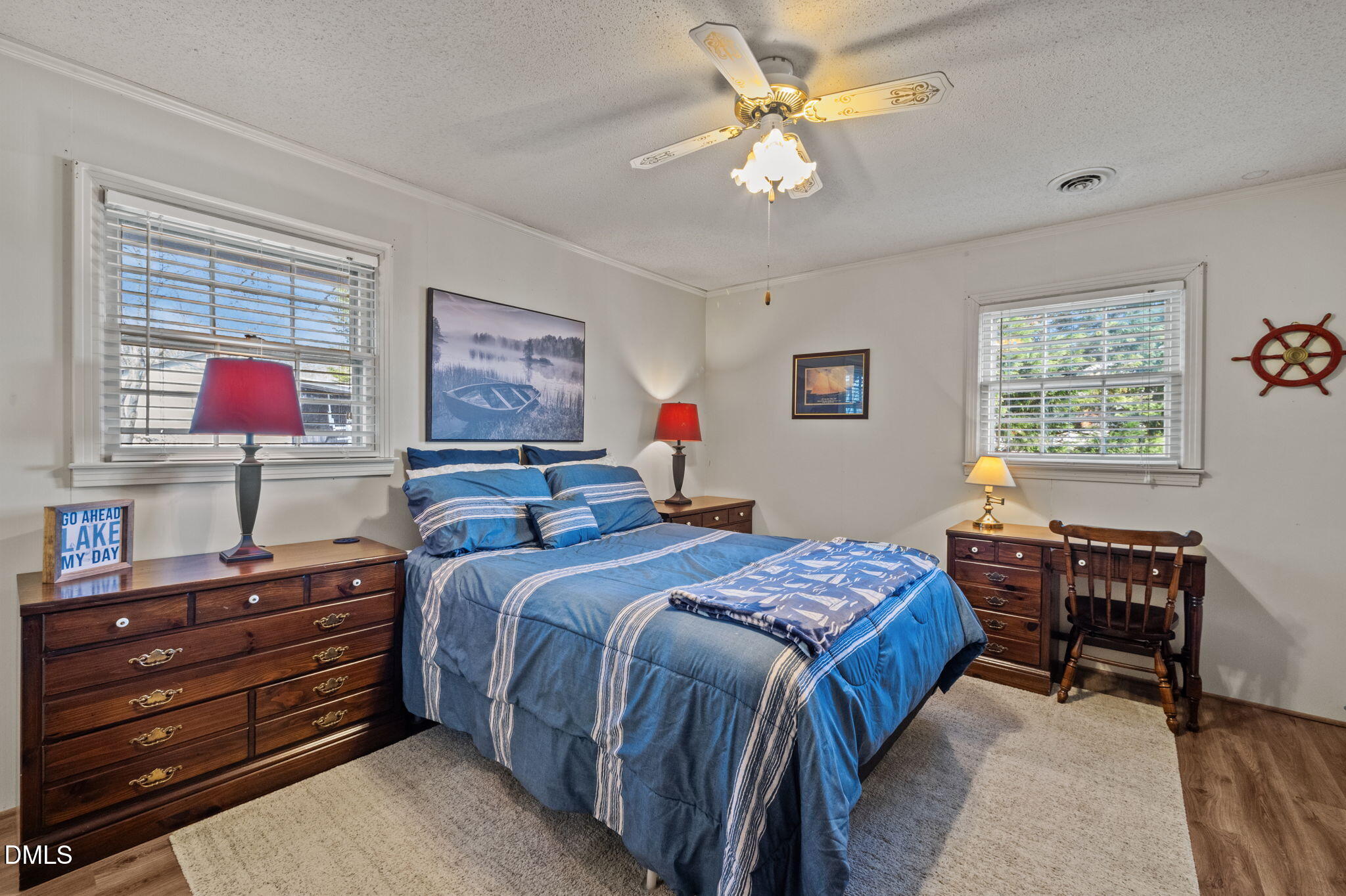 154 Spinnaker Lane Semora, NC 27343 - Photo 27 of 61 a bedroom with a bed and a chandelier
