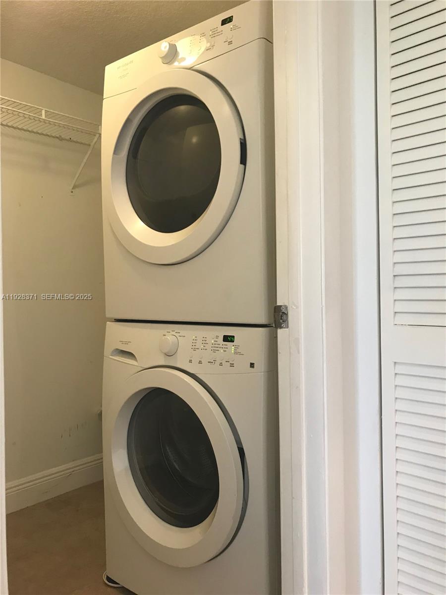 1250 Southwest 113th Terrace, Unit 101 Pembroke Pines, FL 33025 - Photo 9 of 17 a utility room with dryer and washer