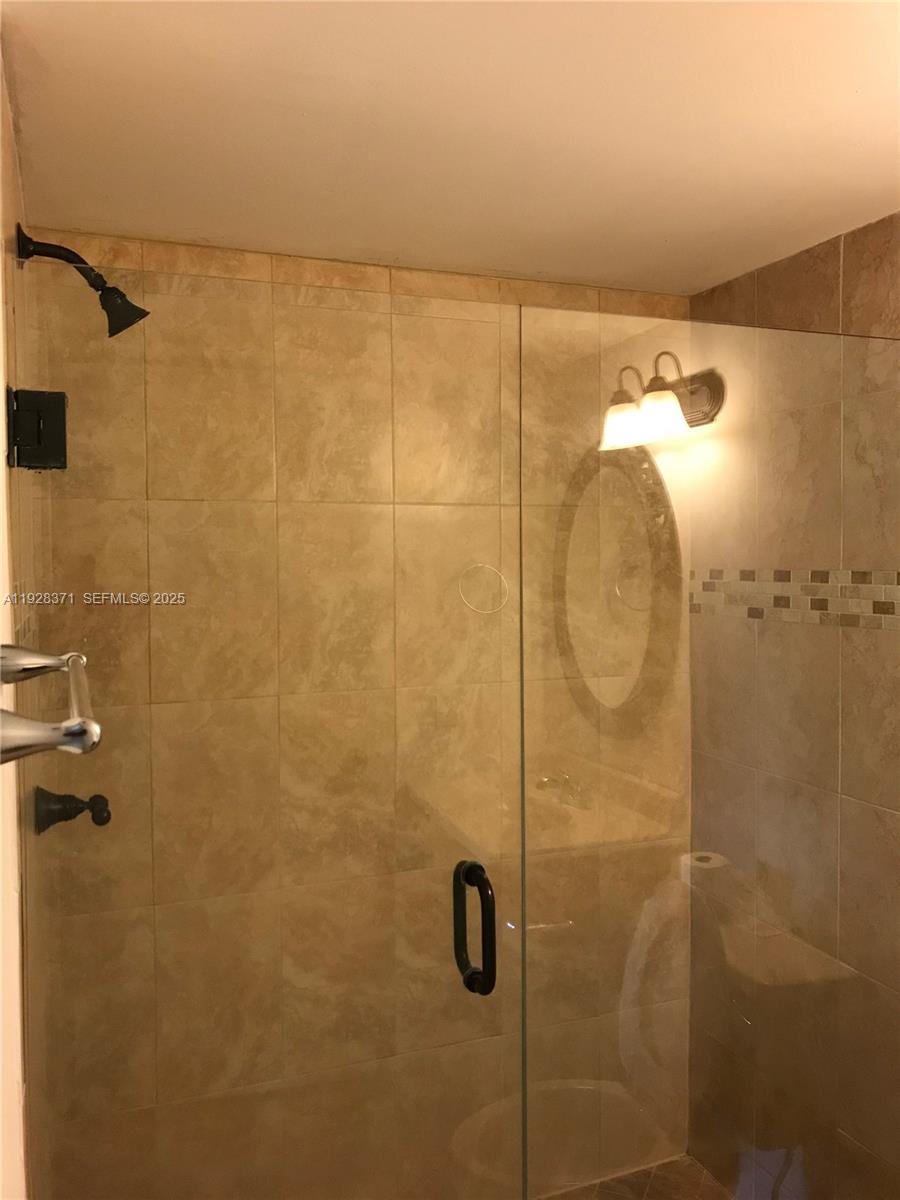 1250 Southwest 113th Terrace, Unit 101 Pembroke Pines, FL 33025 - Photo 10 of 17 a bathroom with a shower