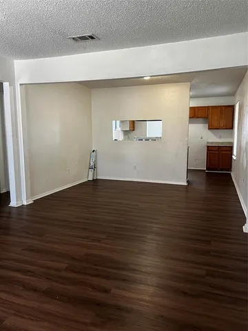 a view of a room with wooden floor