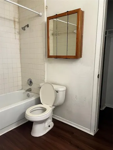 a white toilet sitting next to a bathroom sink