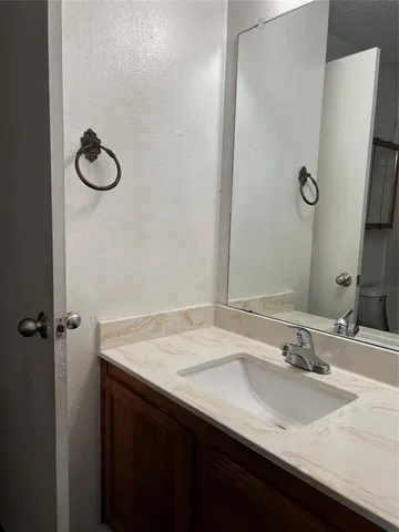 a bathroom with a sink vanity and a mirror