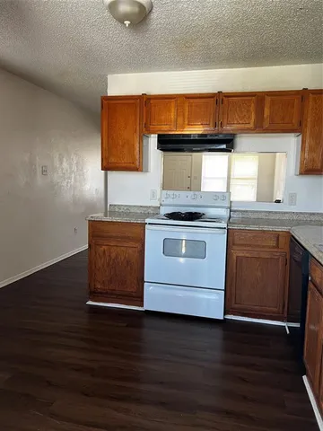 a kitchen with wooden floors and a sink