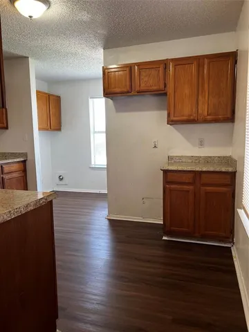 a view of a kitchen with wooden floor and a sink