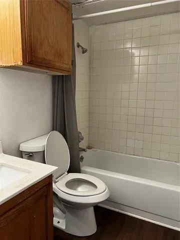 a bathroom with a toilet a sink and bathtub