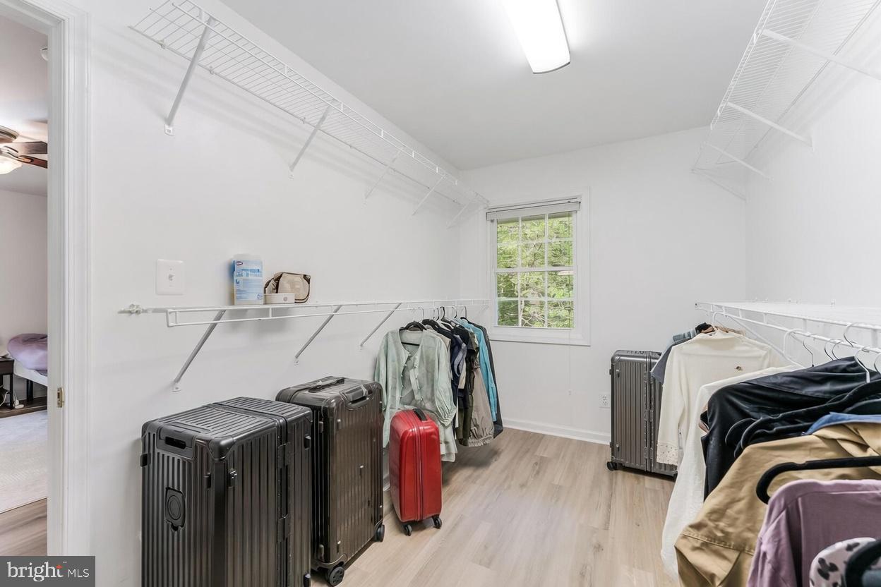 11621 Sourwood Lane Reston, VA 20191 - Photo 13 of 26 a view of walk in closet with clothes and shoes
