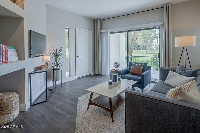 a living room with furniture and a large window