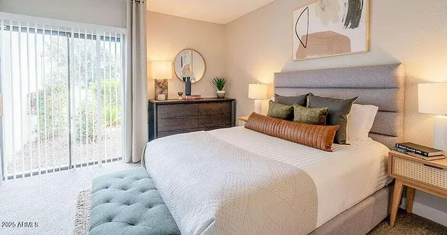 a bedroom with bed and a large window