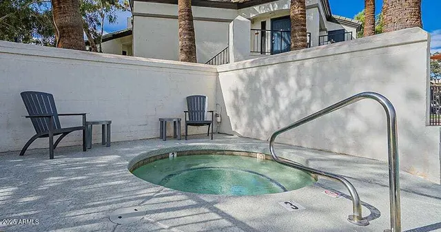 a view of a swimming pool with a lounge chair