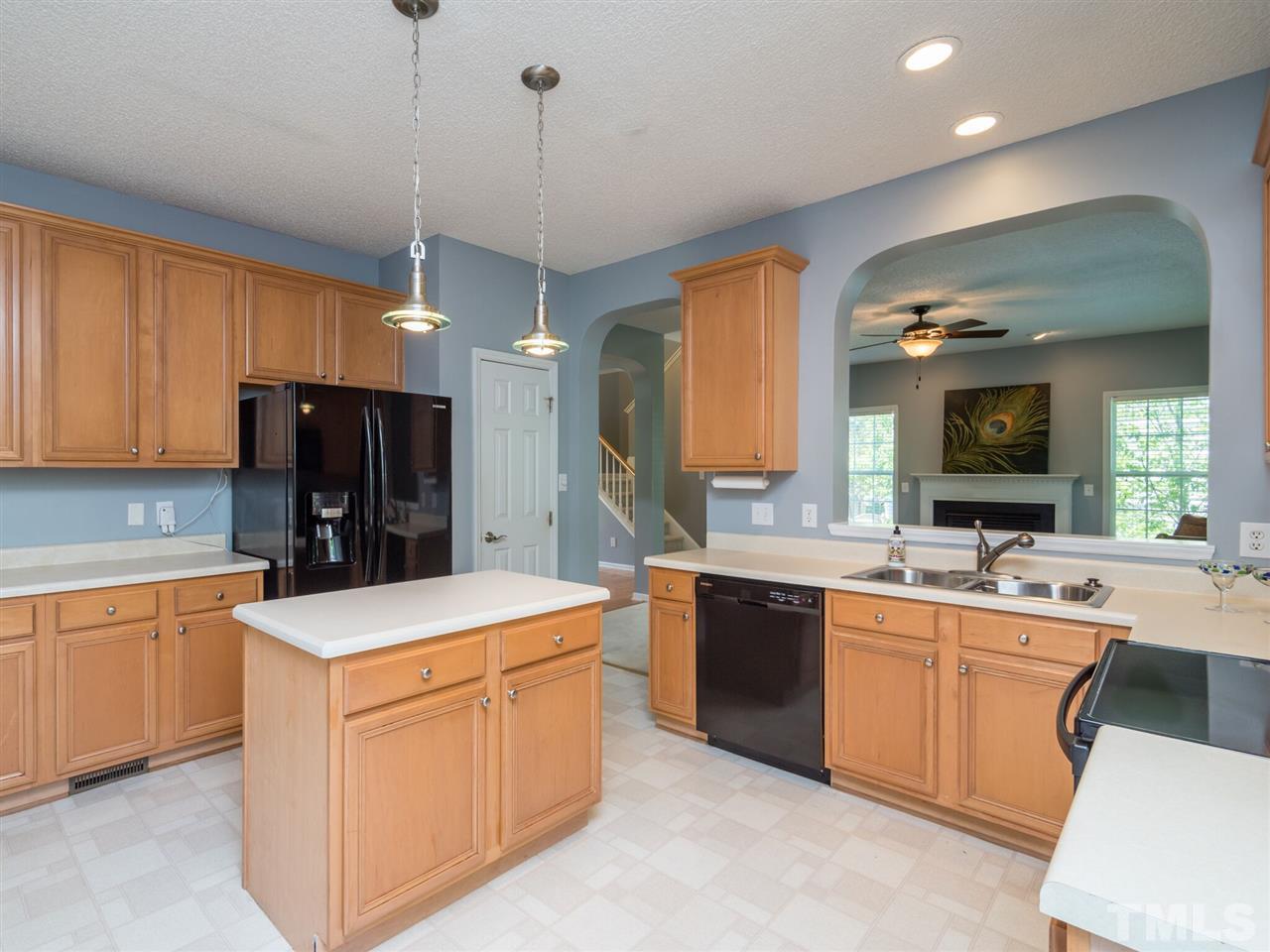 5604 Southern Cross Avenue Raleigh, NC 27606 - Photo 11 of 29 a kitchen that has a sink a stove and chairs