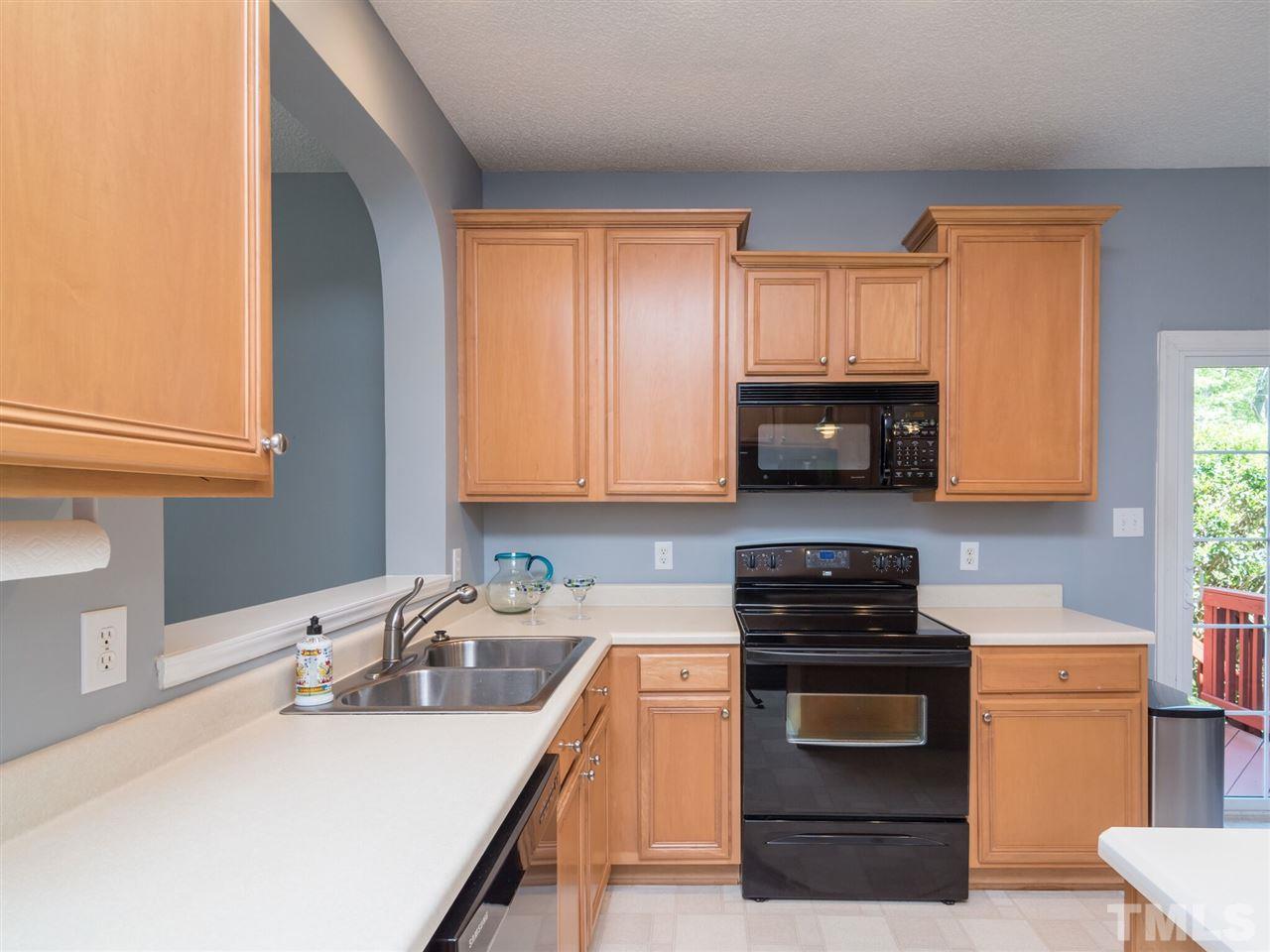 5604 Southern Cross Avenue Raleigh, NC 27606 - Photo 13 of 29 a kitchen with a sink a stove and cabinets