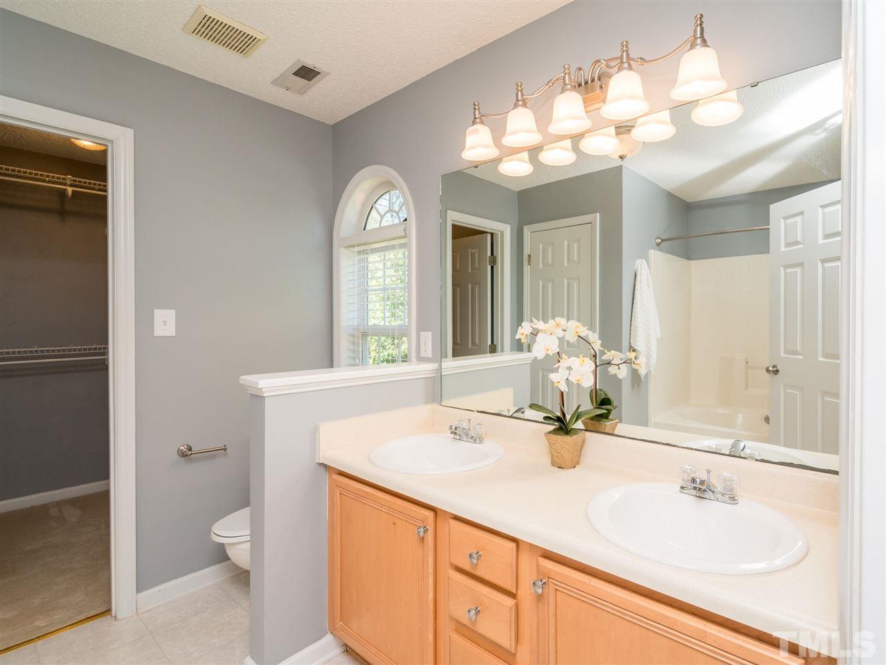 5604 Southern Cross Avenue Raleigh, NC 27606 - Photo 23 of 29 a bathroom with a toilet a sink and a large mirror