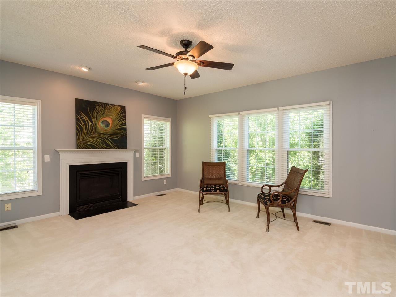 5604 Southern Cross Avenue Raleigh, NC 27606 - Photo 9 of 29 a living room with furniture a fireplace and a flat screen tv
