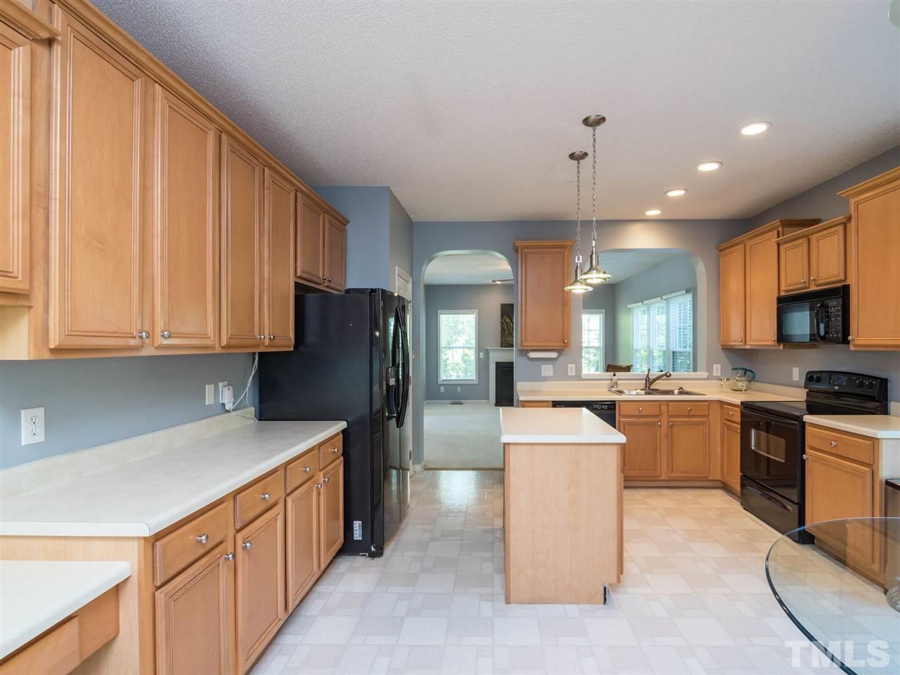 5604 Southern Cross Avenue Raleigh, NC 27606 - Photo 10 of 29 a kitchen with stainless steel appliances granite countertop a sink stove and refrigerator